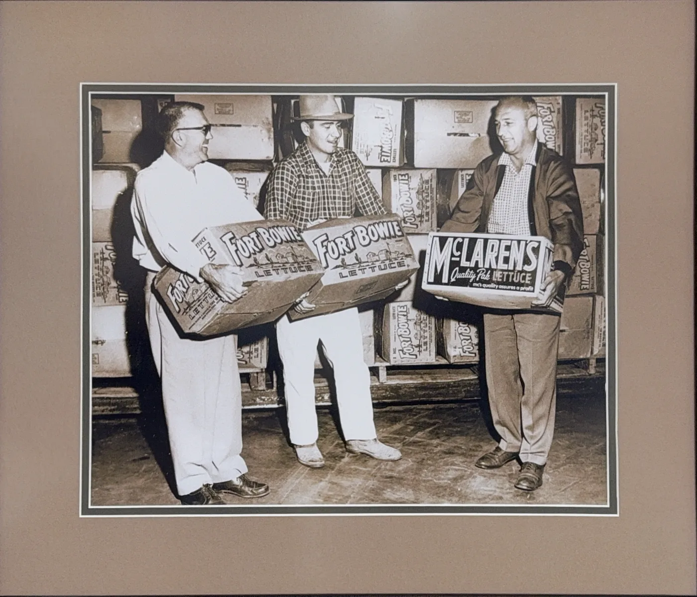 Barkley Company men with crates of Yuma Valley lettuce in a packing warehouse